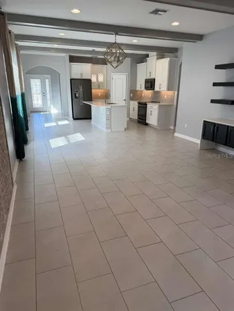 a living room with furniture and a chandelier