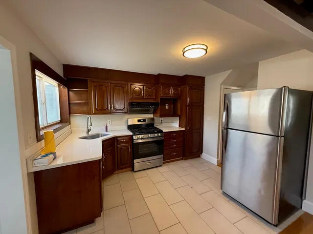 a kitchen with stainless steel appliances granite countertop a refrigerator stove a sink and dishwasher