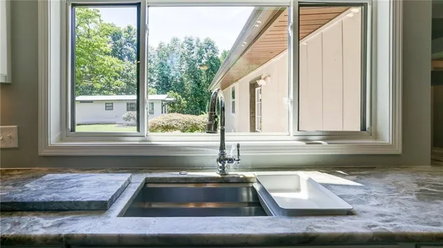 a view of a room with wooden floor and windows