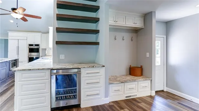 an empty room with wooden floor and closet area