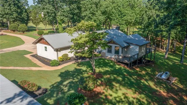an empty room with windows a fireplace and wooden floor