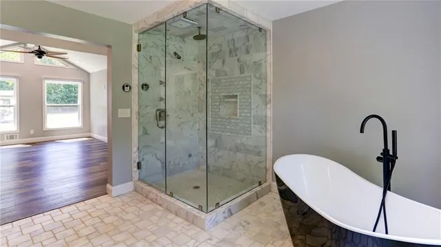 a kitchen with granite countertop white cabinets and a sink