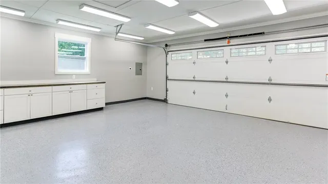 a view of a patio with table and chairs potted plants with wooden floor and fence
