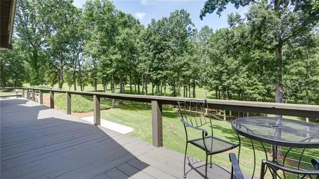 a view of a swimming pool with a chair and floor to ceiling window