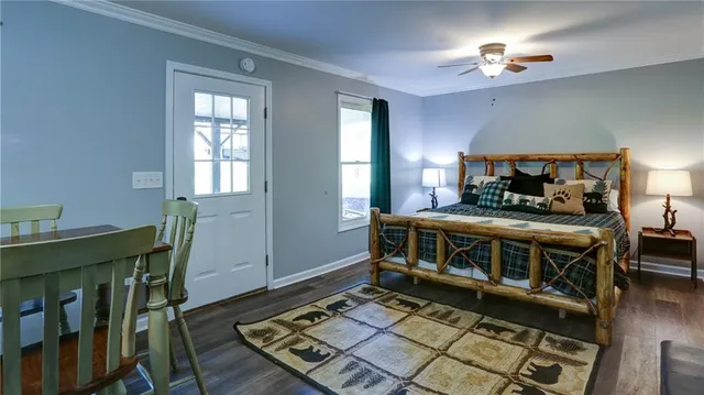 a front view of a house with a garden and trees