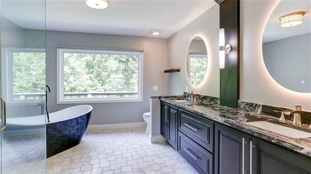 a kitchen with stainless steel appliances granite countertop a stove and a wooden floors