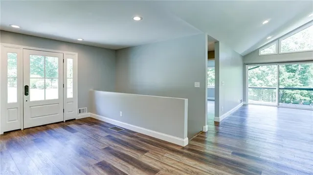 a kitchen with granite countertop white cabinets and stainless steel appliances