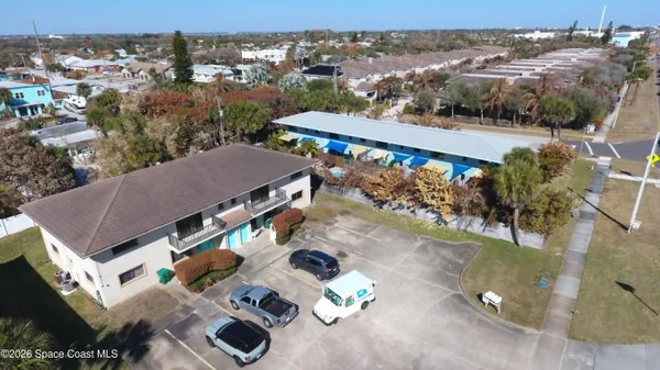 an aerial view of a house with a yard