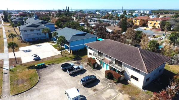 an aerial view of multiple houses with yard