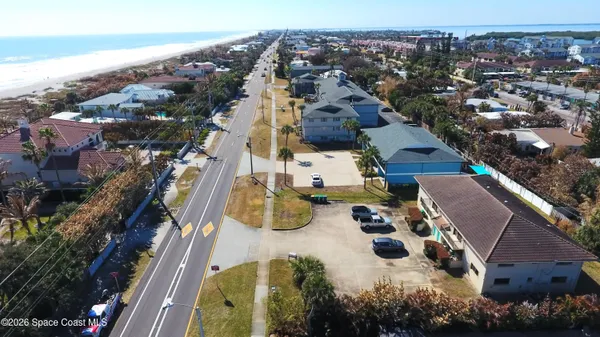 an aerial view of multiple houses with yard
