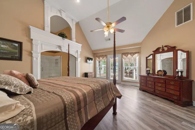 a view of a dining room and livingroom with furniture wooden floor a rug a potted plant and a chandelier