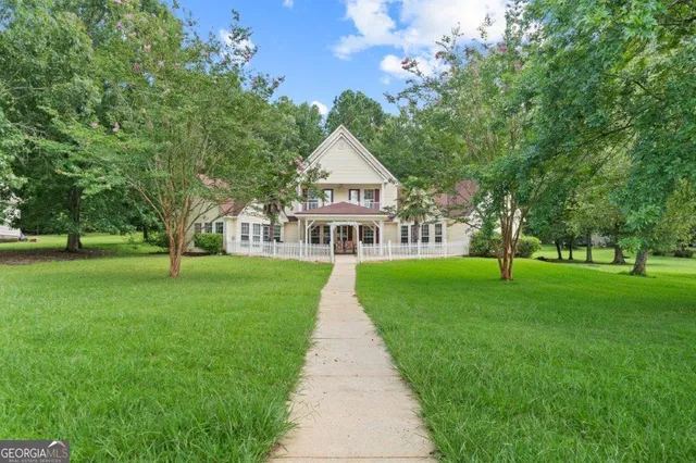 a front view of house with yard and green space