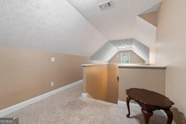 a front view of a house with a yard table and chairs