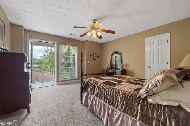 a view of a wooden house with large trees