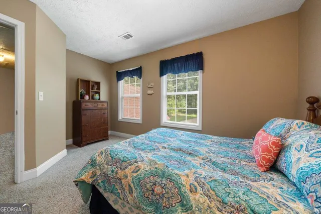 a view of a house with a yard and garage