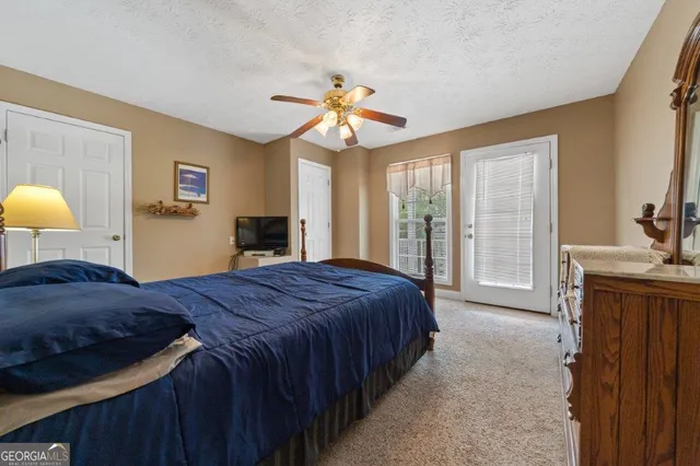an aerial view of a residential houses with outdoor space and lake view