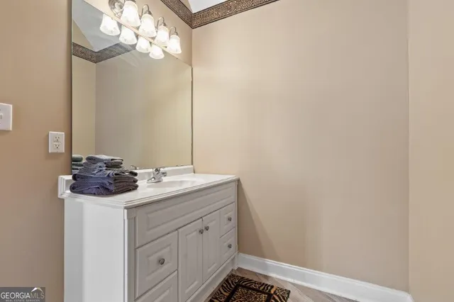 a bedroom with a bed and a large window with wooden floor