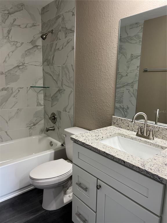 20855 Beach Boulevard Dunnellon, FL 34431 - Photo 13 of 14 a bathroom with a granite countertop toilet a sink and bathtub