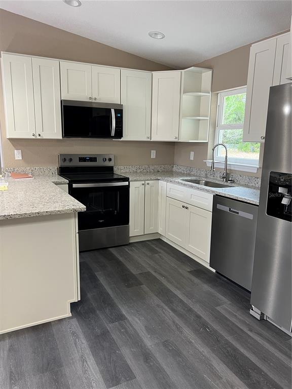 20855 Beach Boulevard Dunnellon, FL 34431 - Photo 3 of 14 a kitchen with granite countertop a sink appliances and cabinets