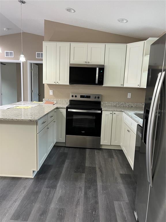 20855 Beach Boulevard Dunnellon, FL 34431 - Photo 4 of 14 a kitchen with granite countertop a refrigerator stove and sink
