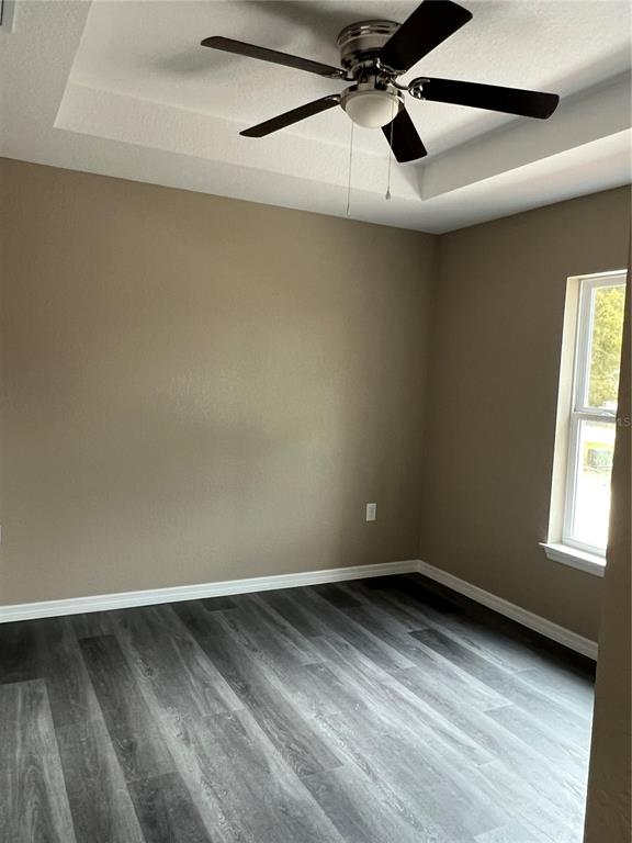 20855 Beach Boulevard Dunnellon, FL 34431 - Photo 8 of 14 an empty room with a window and a ceiling fan