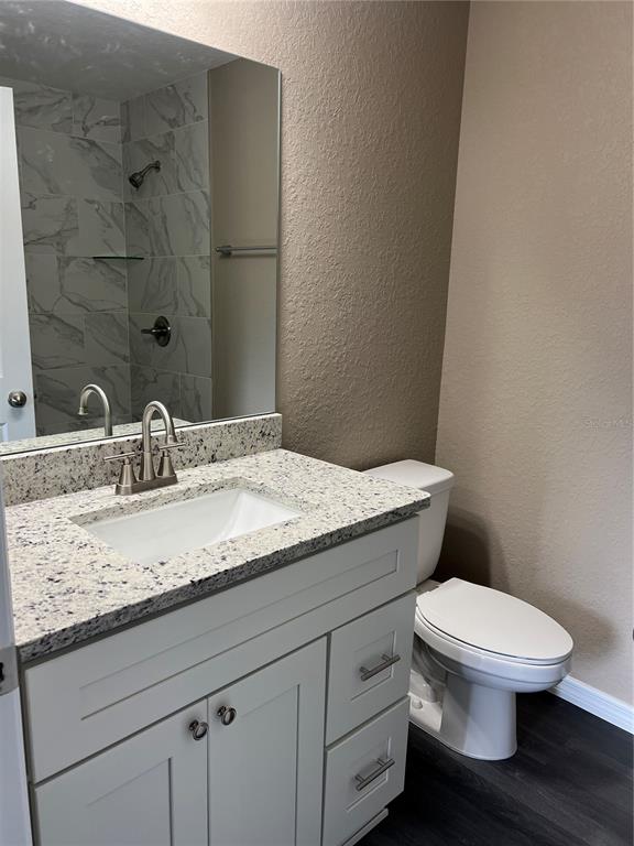 20855 Beach Boulevard Dunnellon, FL 34431 - Photo 9 of 14 a bathroom with a granite countertop toilet and a sink