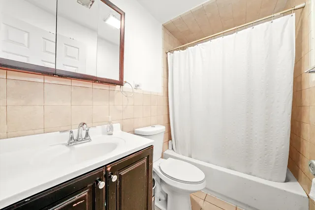a bathroom with a sink a toilet and shower curtain