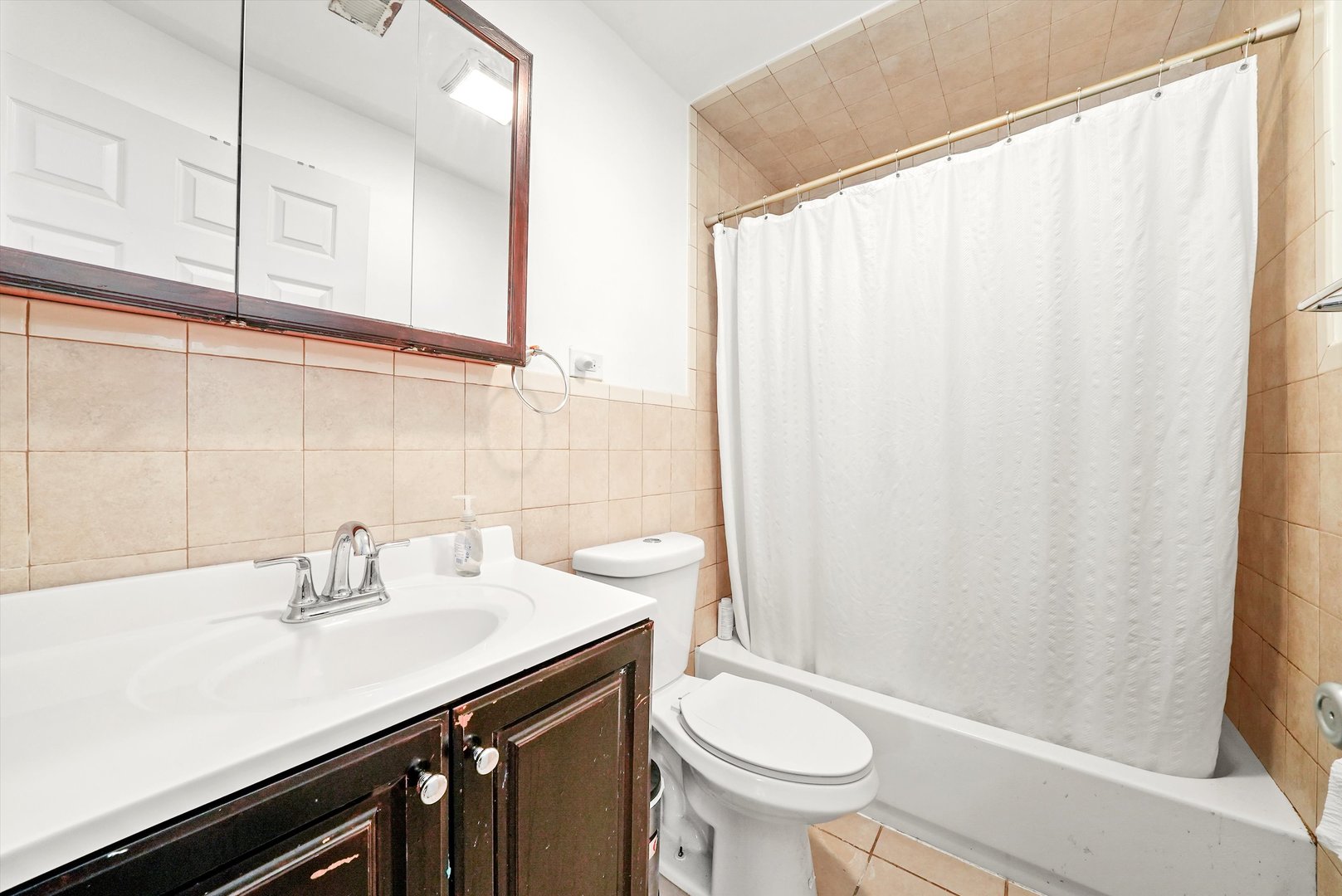 142 West Swann Street Chicago, IL 60609 - Photo 15 of 42 a bathroom with a sink a toilet and shower curtain