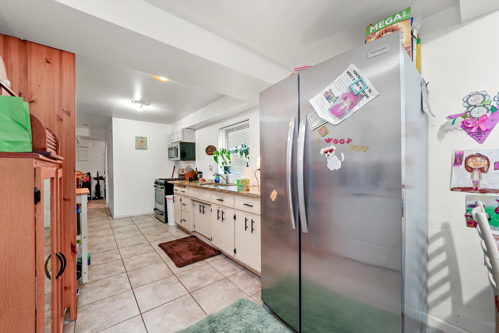 142 West Swann Street Chicago, IL 60609 - Photo 21 of 42 a kitchen with stainless steel appliances kitchen island granite countertop a refrigerator and a stove