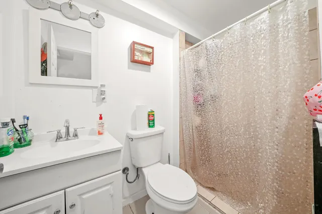 a white toilet sitting next to a bathroom sink