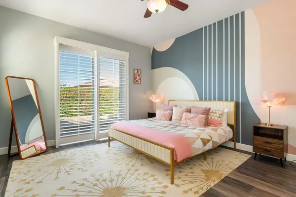 a bedroom with a bed a couch and a chandelier