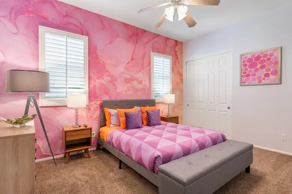 a bedroom with a bed and a window