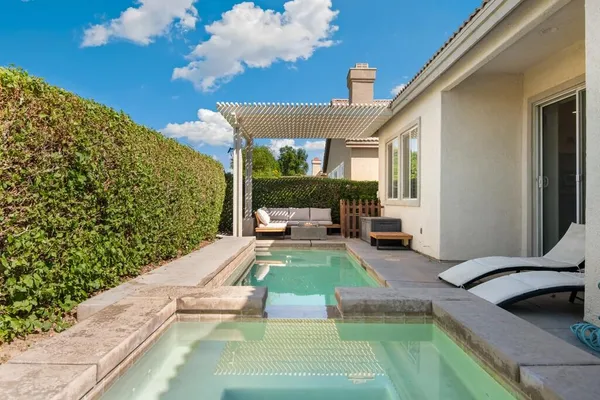 a view of a swimming pool with furniture