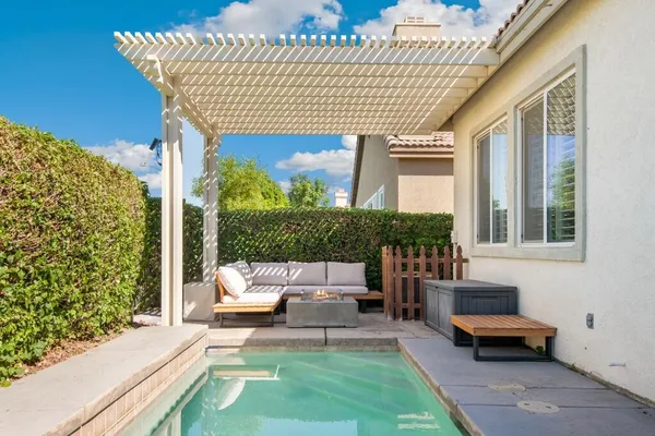a house view with a sitting space and garden