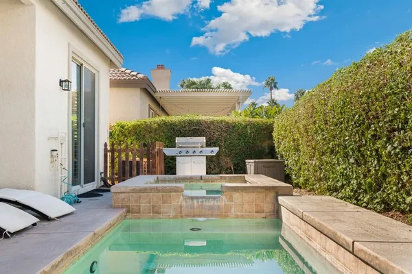 a view of a patio with couches table and chairs and potted plants