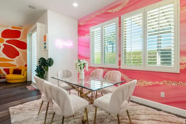 a dining room with furniture and wooden floor