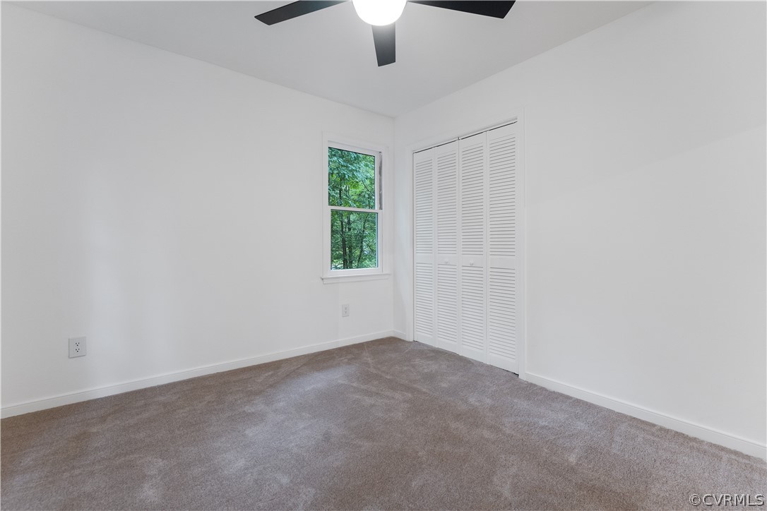 13807 Barnes Spring Road Midlothian, VA 23112 - Photo 37 of 49 an empty room with a chandelier fan and windows