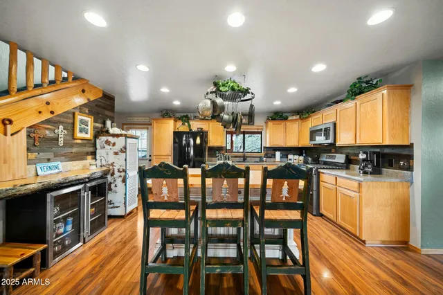 a room with lots of wooden furniture and windows