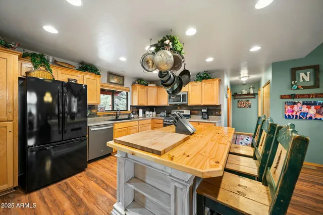 a living room with furniture a fireplace and a large window
