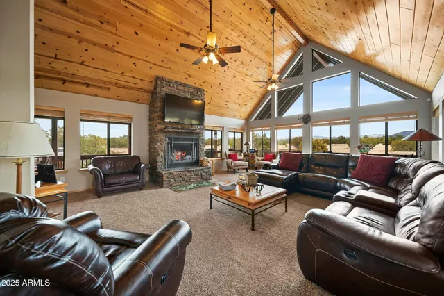 a spacious bedroom with a bed and a tv