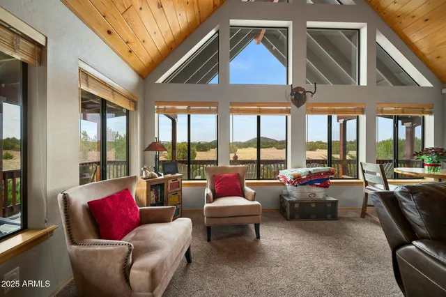 a bedroom with furniture and large windows