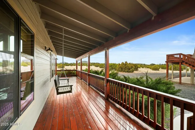 a kitchen with stainless steel appliances granite countertop table chairs stove and refrigerator