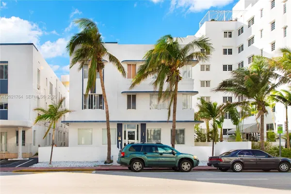 a building with palm tree in front of it