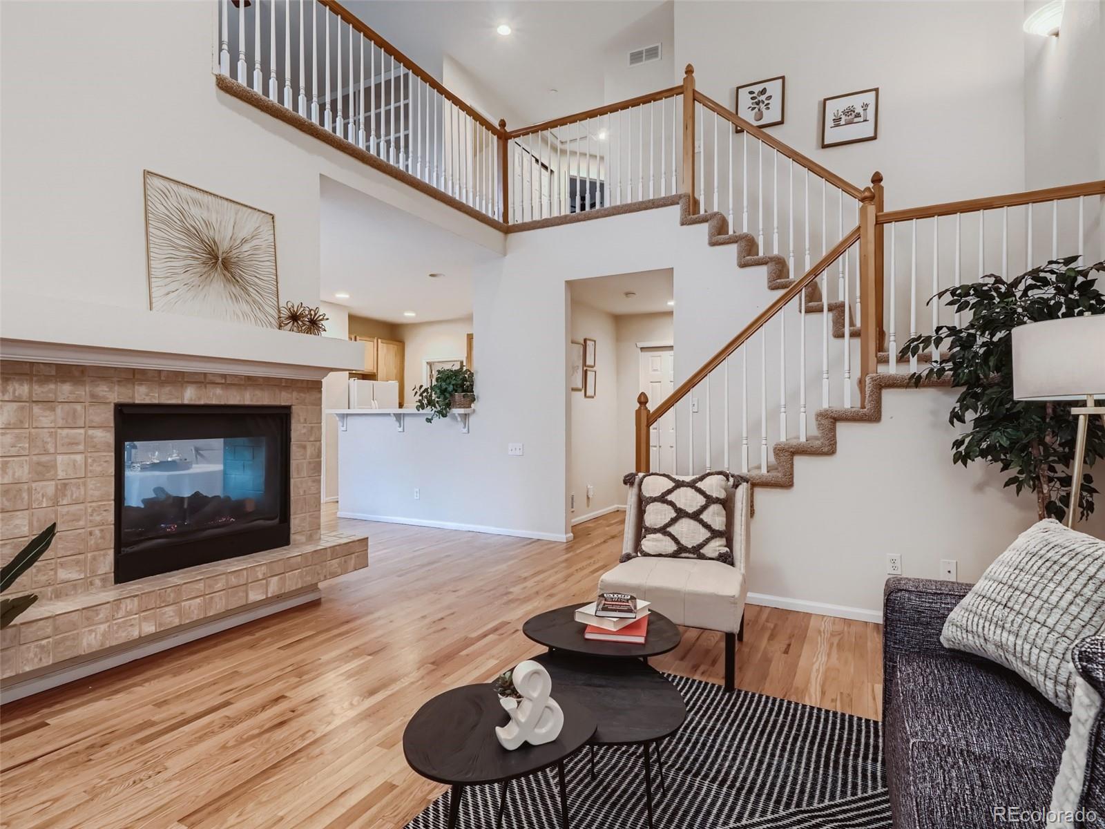 6224 Secrest Street Arvada, CO 80403 - Photo 2 of 16 a living room with furniture and a fireplace
