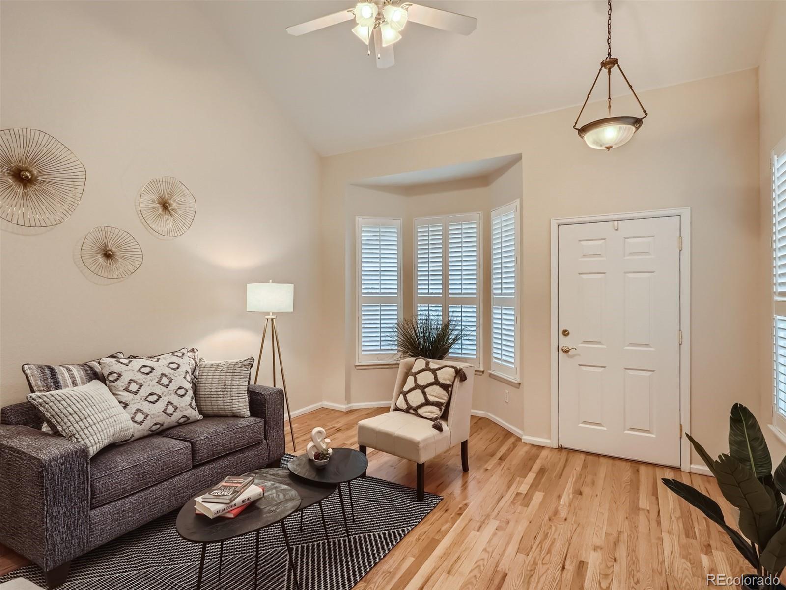 6224 Secrest Street Arvada, CO 80403 - Photo 3 of 16 a living room with furniture and a chandelier