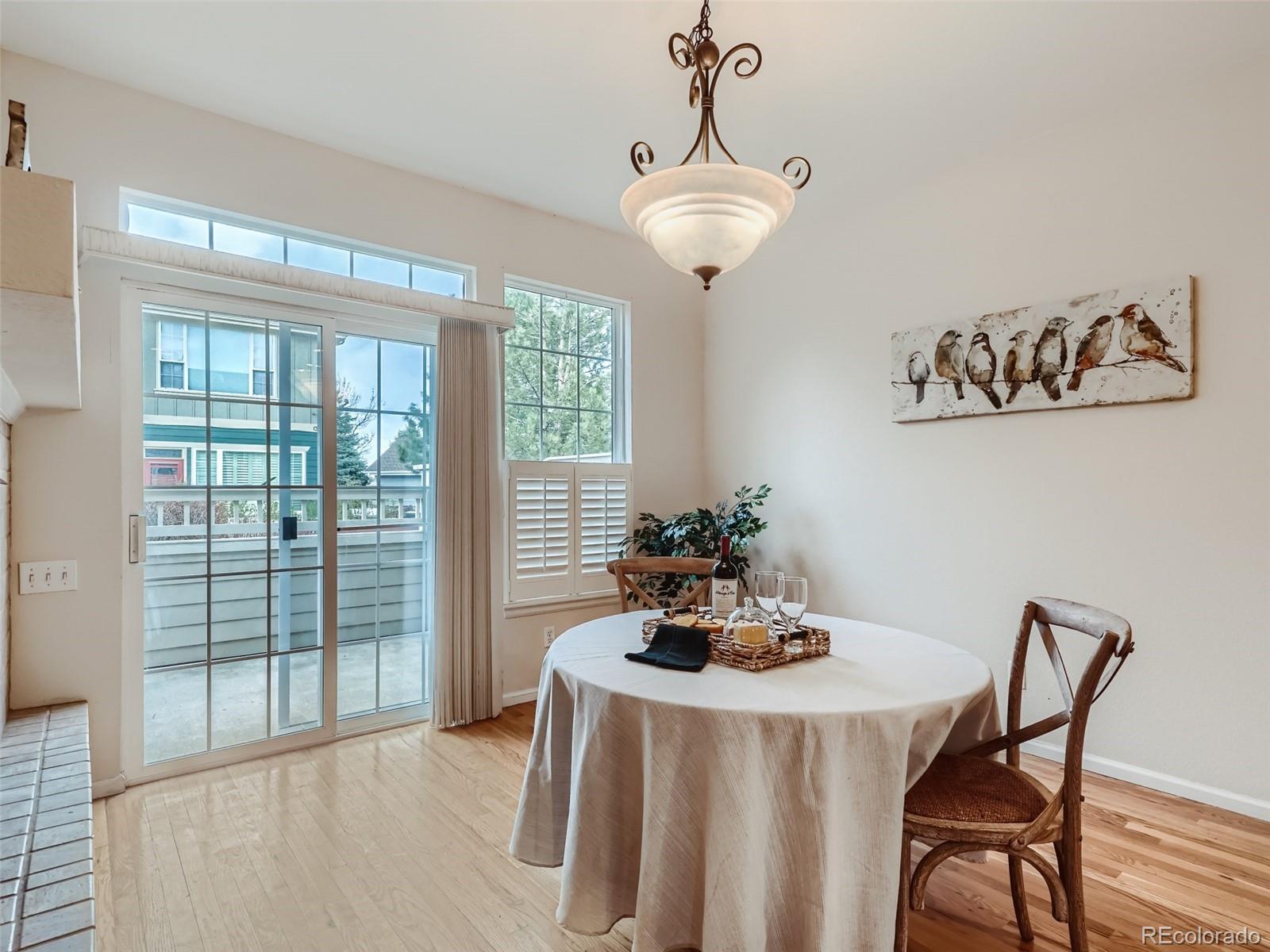 6224 Secrest Street Arvada, CO 80403 - Photo 5 of 16 a dining room with furniture a chandelier and window