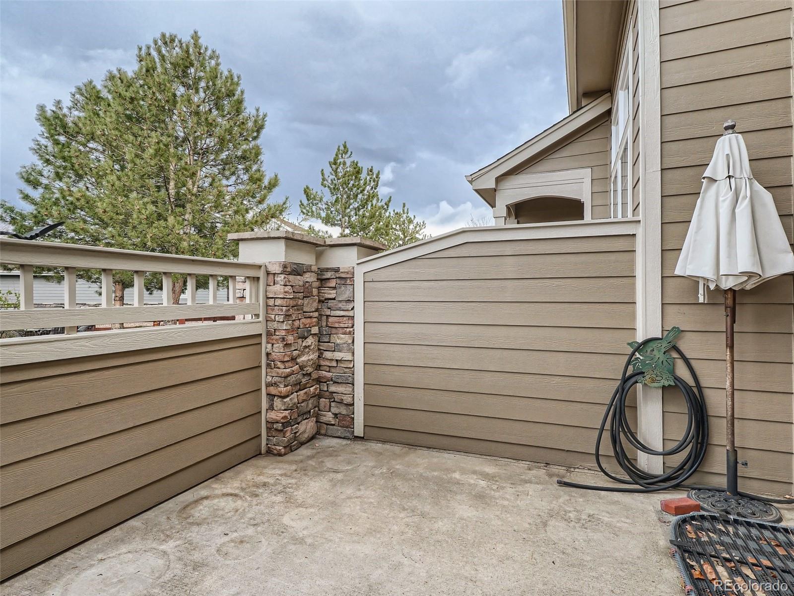 6224 Secrest Street Arvada, CO 80403 - Photo 8 of 16 a view of a house with a small yard and wooden fence