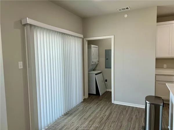 a view of kitchen with stainless steel appliances granite countertop a refrigerator and a stove top oven