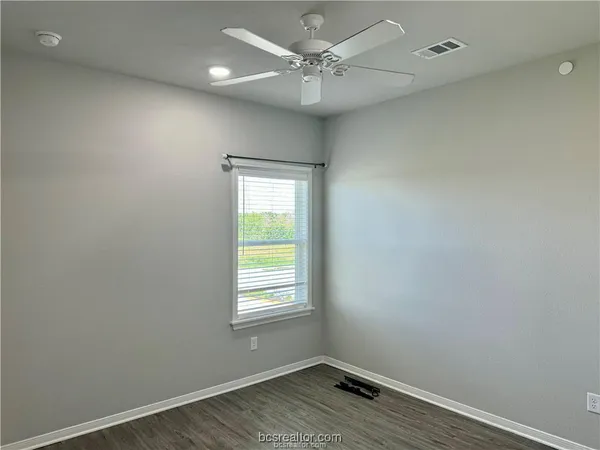 a view of a room with wooden floor and a sink