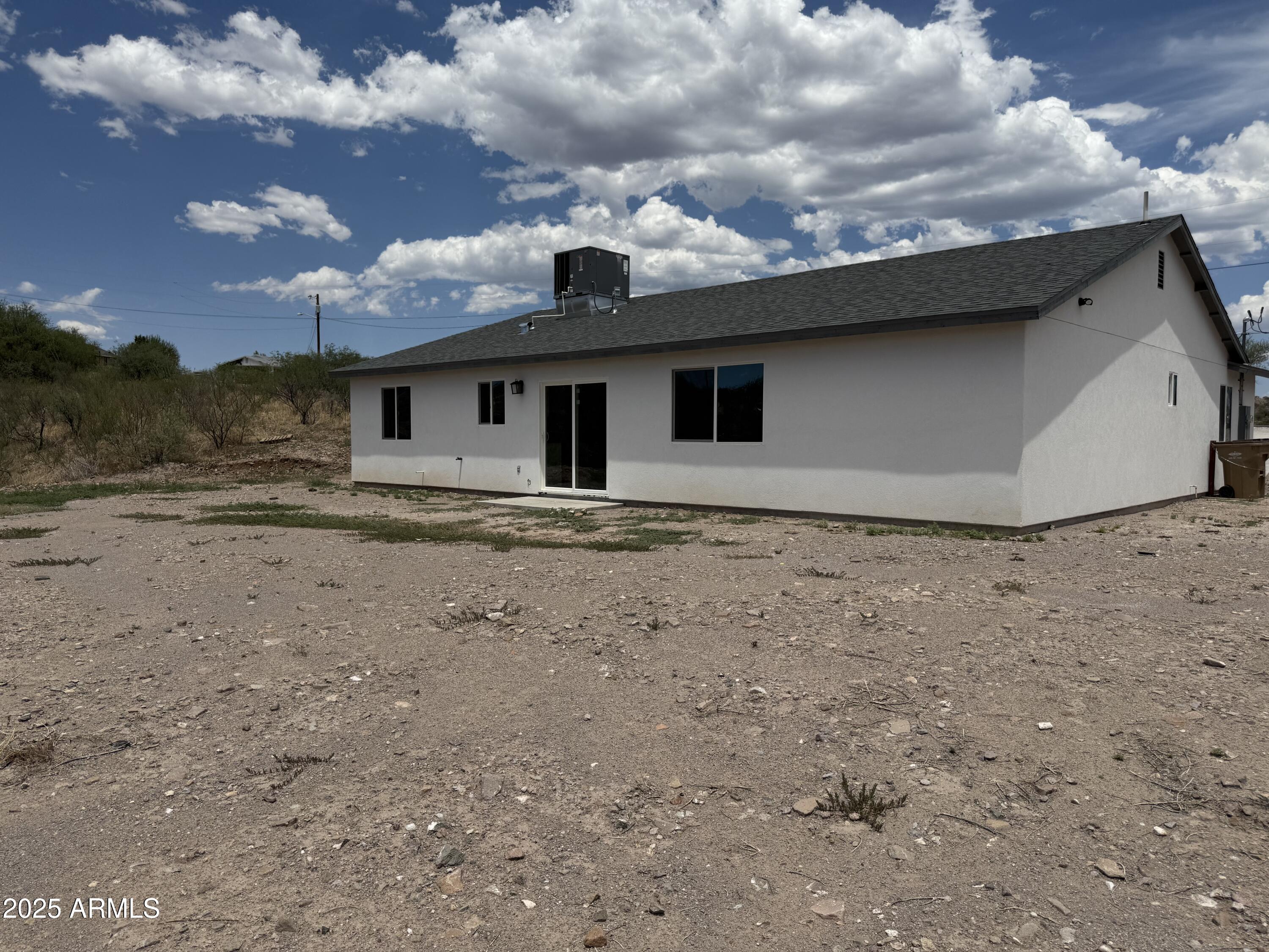 286 Guaymas Court Rio Rico, AZ 85648 - Photo 6 of 16 a view of a dry yard with wooden fence